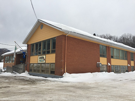 Building image of Anse Saint-Jean Scheduled Outreach Site at 239 St-Jean-Baptiste Street in L'Anse-Saint-Jean